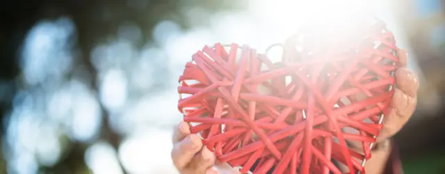Person holding a string heart